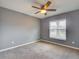 Bedroom features a ceiling fan, neutral carpet, and a large window at 728 Silversmith Cir, Lake Mary, FL 32746
