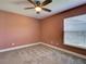 Bedroom features a ceiling fan, neutral carpet, and a window at 728 Silversmith Cir, Lake Mary, FL 32746