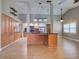 Spacious kitchen with island, stainless appliances, wood cabinetry, and open shelving at 728 Silversmith Cir, Lake Mary, FL 32746