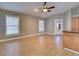 Bright living room next to kitchen features wood flooring and natural light at 728 Silversmith Cir, Lake Mary, FL 32746