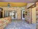 Covered outdoor kitchen with stone accents, granite countertops, and stylish lighting, perfect for entertaining at 728 Silversmith Cir, Lake Mary, FL 32746