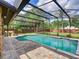 Inviting screened-in pool with brick patio, surrounded by lush landscaping and a privacy fence at 728 Silversmith Cir, Lake Mary, FL 32746