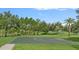 Outdoor basketball court is surrounded by lush landscaping and green grass at 7901 Iceland Gull St, Winter Garden, FL 34787