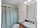 Clean bathroom featuring a toilet, a shower with a curtain, and a single sink vanity at 7901 Iceland Gull St, Winter Garden, FL 34787