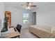 Cozy bedroom with a desk, chair, and a view of the lake, perfect for relaxation or study at 7901 Iceland Gull St, Winter Garden, FL 34787
