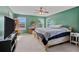 Bright bedroom with natural light, ceiling fan, and comfortable carpet flooring at 7901 Iceland Gull St, Winter Garden, FL 34787