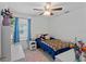 Charming bedroom features a ceiling fan, a window, a bed, and stylish decor at 7901 Iceland Gull St, Winter Garden, FL 34787