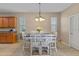 Comfortable dining area features a pendant light fixture and views to the backyard at 7901 Iceland Gull St, Winter Garden, FL 34787