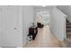 Inviting foyer featuring a decorative wood cabinet, tiled floors and nearby staircase at 7901 Iceland Gull St, Winter Garden, FL 34787