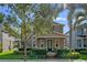 Charming two-story home featuring manicured landscaping, covered porch, and inviting entrance at 7901 Iceland Gull St, Winter Garden, FL 34787