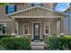 Close-up of a charming front porch with decorative columns and meticulously manicured landscaping at 7901 Iceland Gull St, Winter Garden, FL 34787