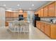 Spacious kitchen with granite countertops, light wood cabinets, and a large island at 7901 Iceland Gull St, Winter Garden, FL 34787