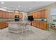 Bright kitchen features a granite countertop island with seating and ample wooden cabinetry at 7901 Iceland Gull St, Winter Garden, FL 34787