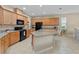Spacious kitchen features granite countertops, wooden cabinetry, and modern appliances at 7901 Iceland Gull St, Winter Garden, FL 34787