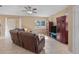 Spacious living room with tile flooring, a ceiling fan, and access to the backyard at 7901 Iceland Gull St, Winter Garden, FL 34787