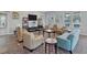 Bright lounge area features plenty of comfortable seating, a TV, and natural light at 7901 Iceland Gull St, Winter Garden, FL 34787