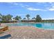 Community pool featuring splash fountain, covered seating, and sun loungers, and brick paver deck at 7901 Iceland Gull St, Winter Garden, FL 34787