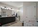 Bathroom features double vanity sinks, a glass-enclosed shower, and a neutral color palette for a clean aesthetic at 9153 Carmela Ave, Davenport, FL 33897
