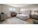 Comfortable bedroom with a cozy rug, crib, and a window offering natural light at 9153 Carmela Ave, Davenport, FL 33897