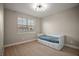 Bedroom with laminate wood floors, neutral paint, and a large window with blinds at 9153 Carmela Ave, Davenport, FL 33897