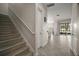 Entryway showcases staircase and tile flooring leading to an open living space with sliding glass doors to the backyard at 9153 Carmela Ave, Davenport, FL 33897