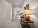Spacious entryway with table, decorated with lamp and vases, and tiled floor at 9153 Carmela Ave, Davenport, FL 33897