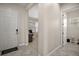Hallway view showing entrances to an office and a bathroom, featuring tile and wood flooring at 9153 Carmela Ave, Davenport, FL 33897