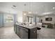 Open kitchen features a large island with granite countertop, pendant lighting, stainless steel appliances, and barstool seating at 9153 Carmela Ave, Davenport, FL 33897