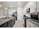 Updated kitchen featuring modern stainless steel appliances, granite countertops, and tile backsplash at 9153 Carmela Ave, Davenport, FL 33897