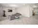 Open-concept living room with tile floors, comfortable seating, and lots of natural light at 9153 Carmela Ave, Davenport, FL 33897