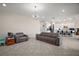Open living room with tiled floor, modern lighting, and comfortable seating at 9153 Carmela Ave, Davenport, FL 33897