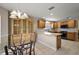 Open concept kitchen and dining area with pendant lights and a light wood china cabinet at 953 Mayo Ct, The Villages, FL 32162