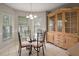 Dining area featuring tile flooring and a wooden china cabinet with glass doors at 953 Mayo Ct, The Villages, FL 32162