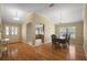 Bright dining area showcasing hardwood floors, chandelier, and seamless flow to the kitchen for easy entertaining at 953 Mayo Ct, The Villages, FL 32162