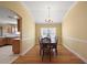 Charming dining room with hardwood floors, a chandelier, and ample natural light from a large window at 953 Mayo Ct, The Villages, FL 32162