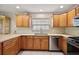 Bright kitchen with stainless steel appliances, tiled backsplash, and solid surface countertops at 953 Mayo Ct, The Villages, FL 32162