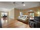 Spacious living room featuring wood floors, comfortable seating, and a bright, open layout at 953 Mayo Ct, The Villages, FL 32162