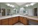 Spacious main bathroom featuring dual sinks, ample counter space, and a large mirror at 953 Mayo Ct, The Villages, FL 32162