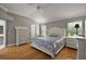 Serene main bedroom featuring a vaulted ceiling, hardwood floors, and ample natural light from two windows at 953 Mayo Ct, The Villages, FL 32162