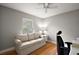 Comfortable office space featuring a window, hardwood floors, and a neutral sofa at 953 Mayo Ct, The Villages, FL 32162