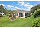 The sunroom of this home provides a seamless blend of indoor and outdoor living and beautiful landscaping at 953 Mayo Ct, The Villages, FL 32162