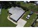 Aerial shot of the home showing the roofline, driveway, landscaping, and surrounding green lawn area at 1007 Cr 463B, Lake Panasoffkee, FL 33538