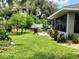 Backyard with lush lawn and plantings, perfect for outdoor entertaining and relaxation at 1007 Cr 463B, Lake Panasoffkee, FL 33538