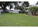 Expansive backyard with well-maintained lawn and mature trees for outdoor enjoyment at 1007 Cr 463B, Lake Panasoffkee, FL 33538
