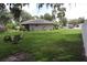 Grassy backyard with green trees and lush plants at 1007 Cr 463B, Lake Panasoffkee, FL 33538
