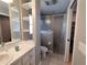 Bathroom with tile floors, vanity, and walk-in shower at 1007 Cr 463B, Lake Panasoffkee, FL 33538