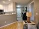 Open-concept design with a view of the entryway with white cabinets and hardwood floors at 1007 Cr 463B, Lake Panasoffkee, FL 33538