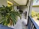 A view of the covered front porch featuring a potted palm, a seating area, and a secure entrance at 1007 Cr 463B, Lake Panasoffkee, FL 33538