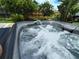 Inviting hot tub with bubbling water is set in a beautifully landscaped yard at 1007 Cr 463B, Lake Panasoffkee, FL 33538