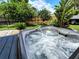 Relaxing hot tub with lush tropical landscaping offers a private outdoor retreat at 1007 Cr 463B, Lake Panasoffkee, FL 33538